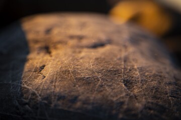 Stony beach stones and rocks sunlit in the evening closeup, texture sunset and sunrise